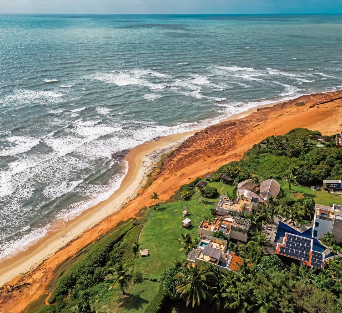 Aerial view of Kilombo Villas with villas, gardens and red cliffs at Sibaúma beach